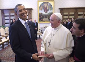 U.S. President Obama shares laugh with Pope Francis as he receives copy of the pope's apostolic exhortation, "Evangelii Gaudium" during private audience at Vatican