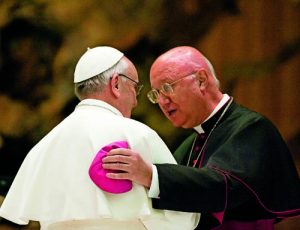 Archbishop Celli embraces Pope Francis during audience with journalist at Vatican