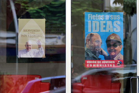 cartel de la visita del papa Francisco al lado de un cartel de Fidel y Raúl Castro antes del viaje a Cuba y Estados Unidos 19-28 septiembre 2015