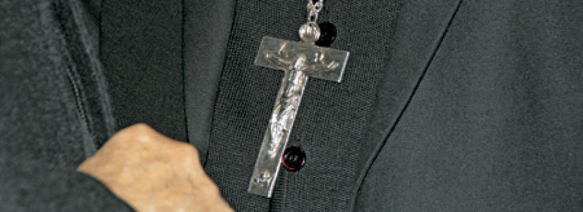 cruz pectoral crucifijo de un obispo vestido de negro