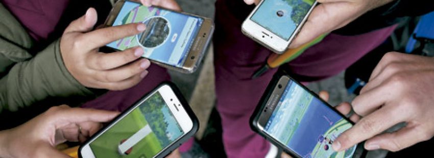 grupo de personas jugando a Pokemon Go en sus teléfonos móviles