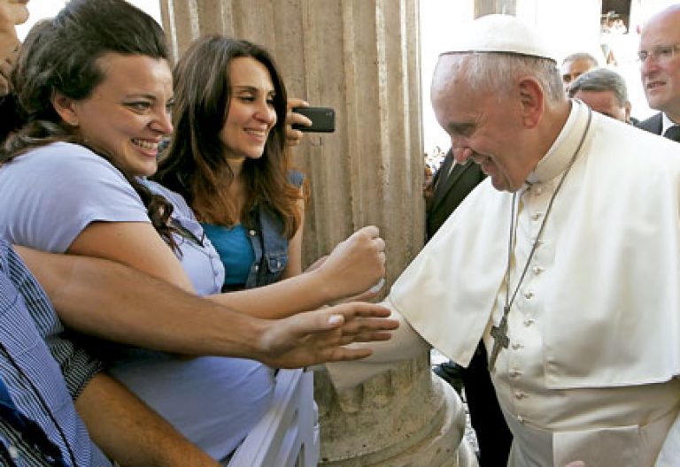 papa Francisco con una mujer embarazada bendiciéndo al bebé en su vientre