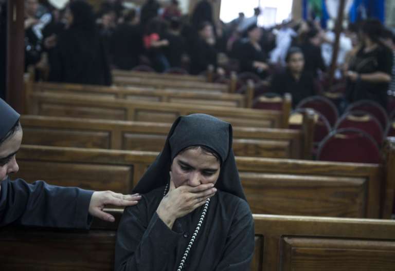 Una mujer llora mientras es consolada durante el funeral de las víctimas de un atentado perpetrado en la entrada del Monasterio de San Samuel el Confesor 26 mayo 2017