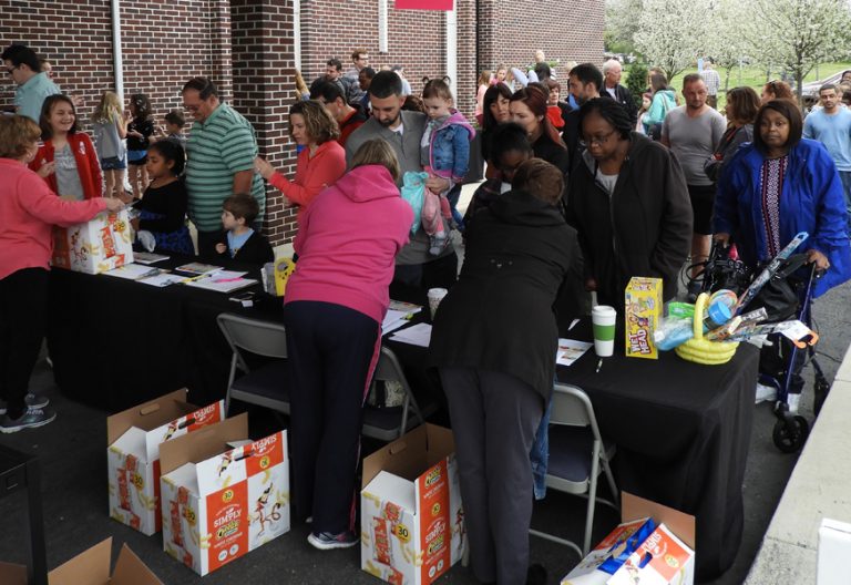 grupo de personas haciendo cola para recibir alimentos por parte de voluntarios
