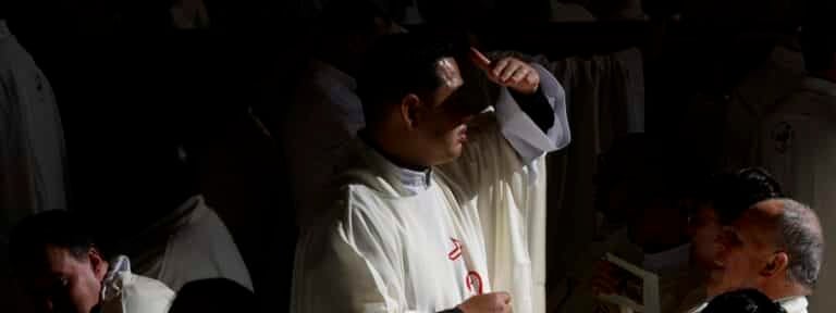 Un sacerdote, durante la misa en la basílica de San Pedro