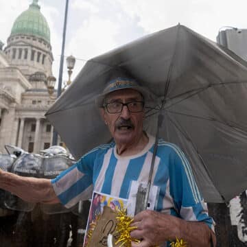 Un hombre sostiene una cruz durante una manifestación contra la reforma laboral en Buenos Aires