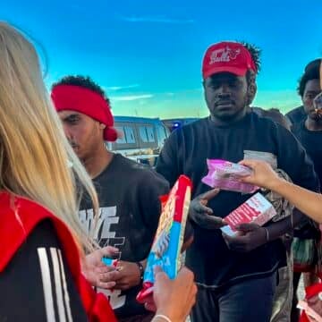 Voluntarias de Cruz Roja reparten alimentos a los migrantes de Ceuta. Foto: Efe