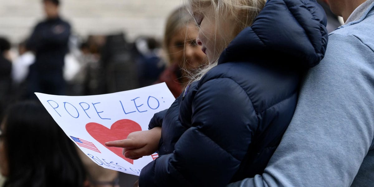 Una niña sostiene un dibujo para el Papa durante la audiencia general